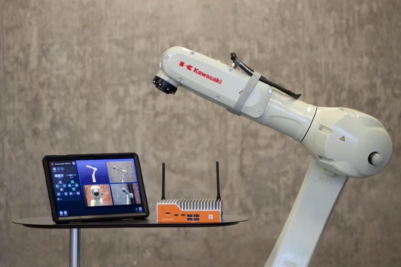 Industrial robotic arm working inside an AI-assisted manufacturing cell