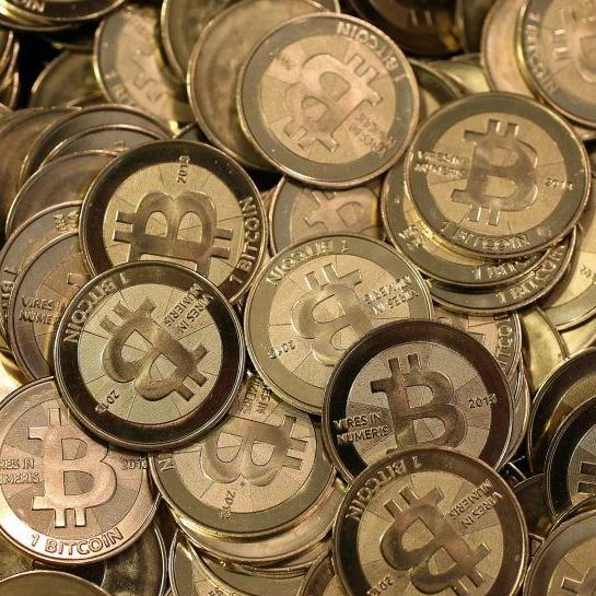 Physical cryptocurrency coins representing the bridge between digital assets and everyday payments.