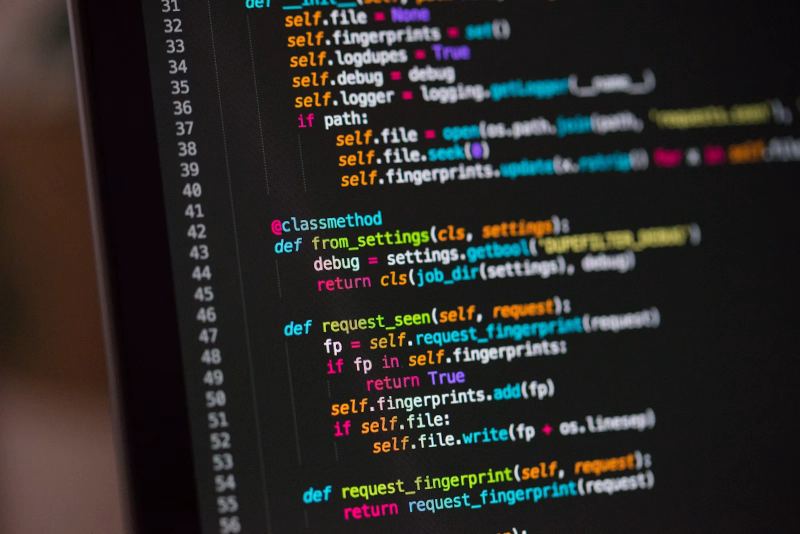 Software developer coding on a laptop in a modern workspace.