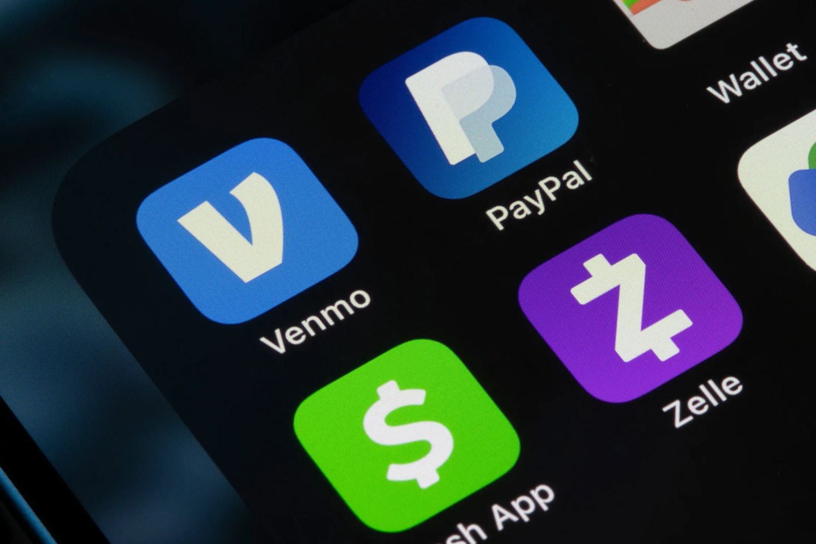 Digital wallet and payment rails on a phone screen with campus and app-store imagery