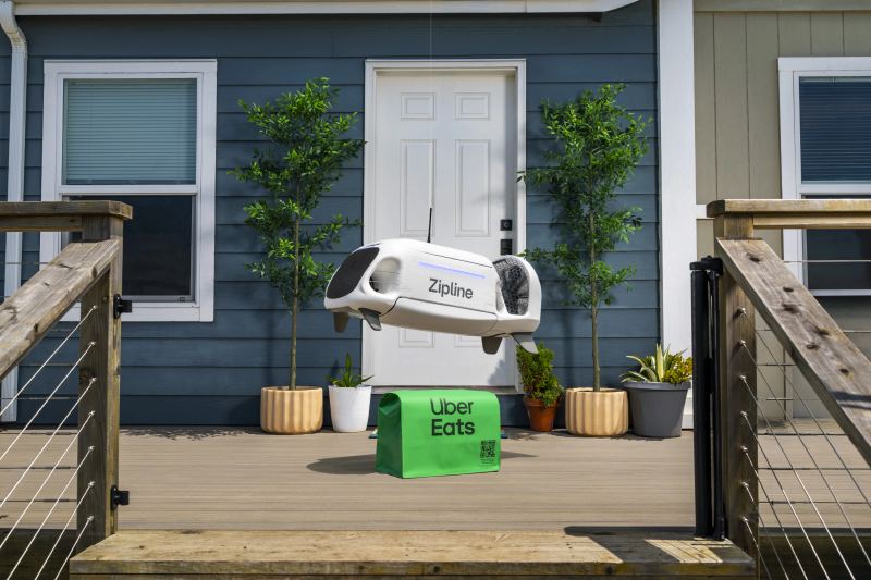 Zipline drone delivering an Uber Eats package to a house deck.