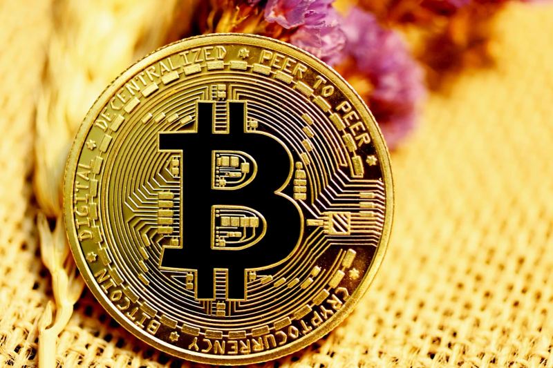 Cryptocurrency coin beside a blue financial chart