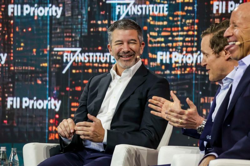 Travis Kalanick speaking at an international technology conference outlining automation and logistics