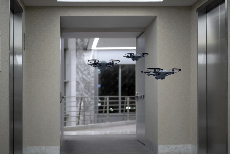 Autonomous aerial drones operating in synchronized formation representing cooperative multi-vehicle swarm navigation.