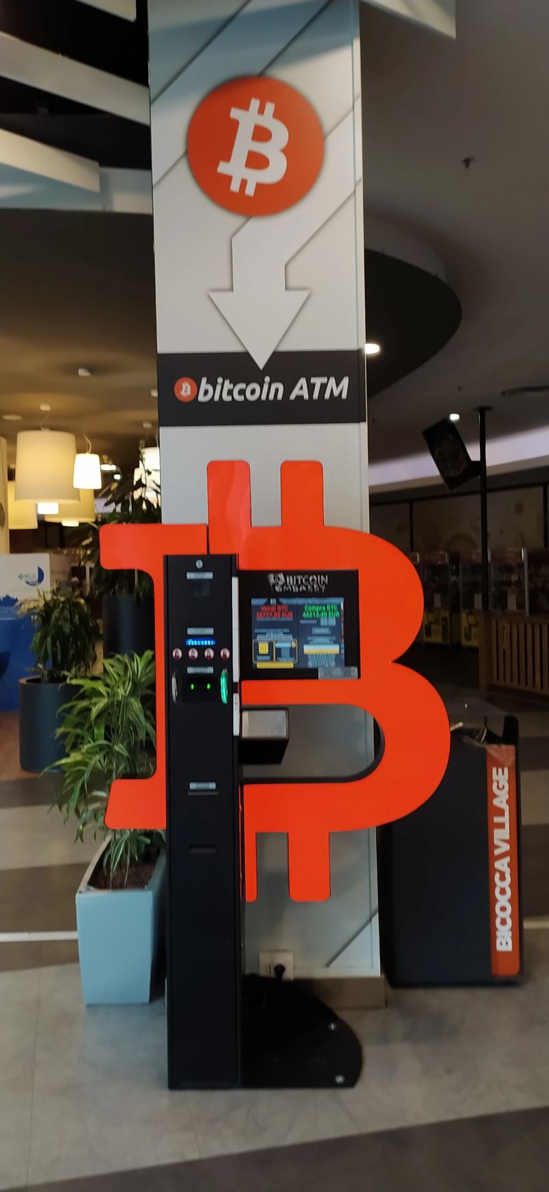 Cryptocurrency automated teller machine operating in a commercial center for digital currency access.