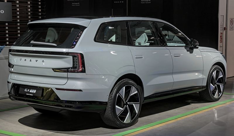 Volvo EX90 luxury electric vehicle featuring advanced digital cockpit architecture on display at an automotive exposition.