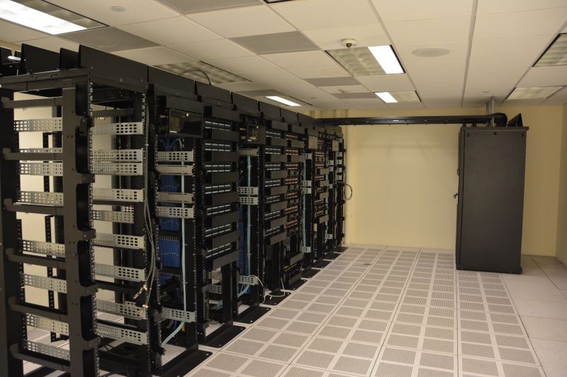 Rows of cloud server racks illuminated inside a modern high-density enterprise datacenter facility