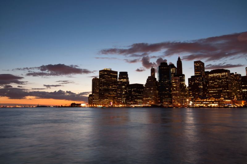 Dramatic high-angle panoramic photograph of the Manhattan cityscape at twilight matching the game setting