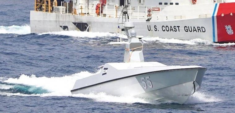 An unmanned surface vessel navigating open maritime waters during autonomous cooperative formation exercises