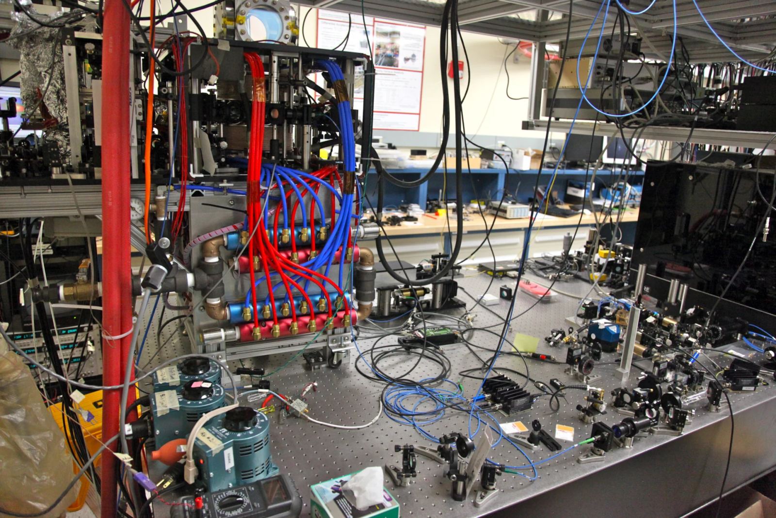 Laser optics experimental bench illustrating coherent light manipulation for photonic quantum computing