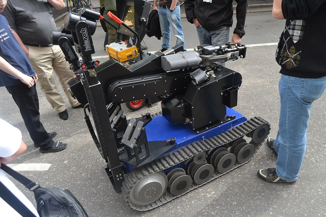Heavy tracked military unmanned ground vehicle featuring articulated manipulator arm for hazardous field operations