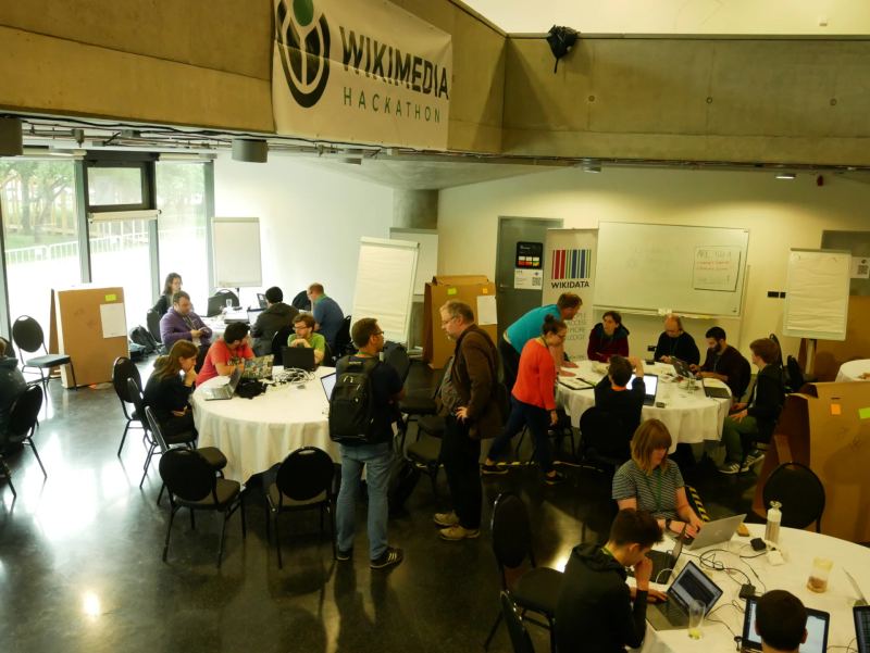 Software engineering collaborative hacking floor with developers writing and debugging computer code