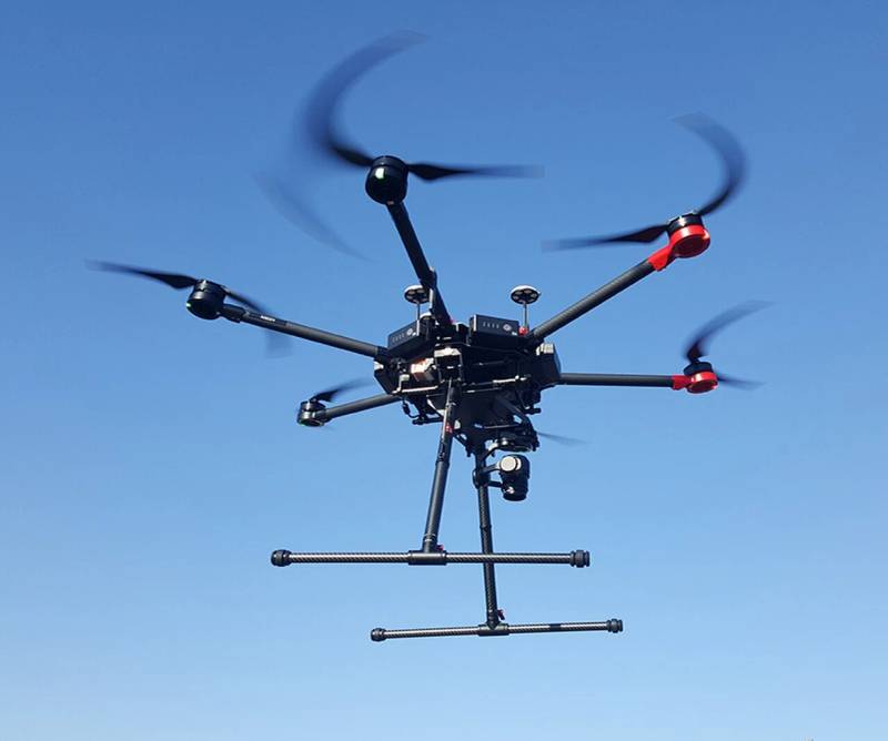 Commercial enterprise quadcopter drone aircraft positioned on a landing surface during field inspection trials.