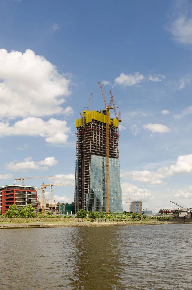 European financial institution towers highlighting the convergence of fiat settlement and cross-border digital assets.