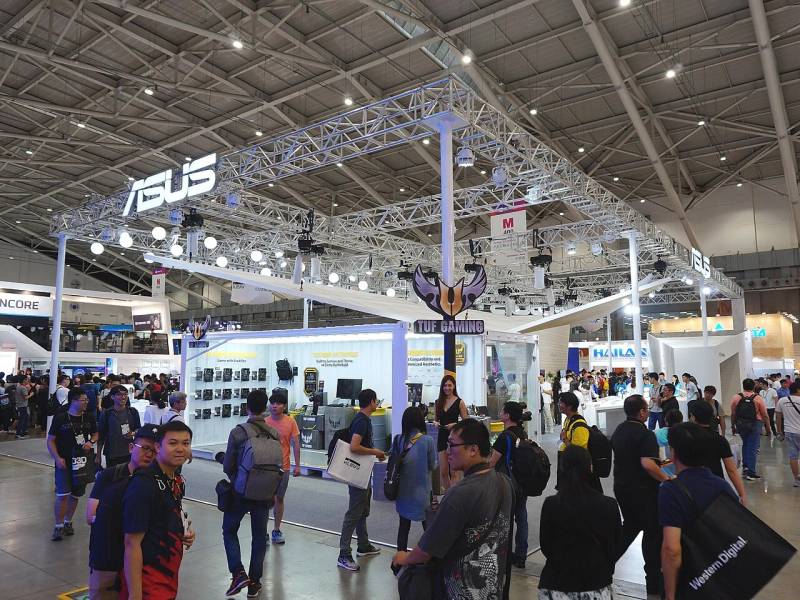 Gaming hardware exhibition booth featuring portable PC gaming systems and esports equipment.