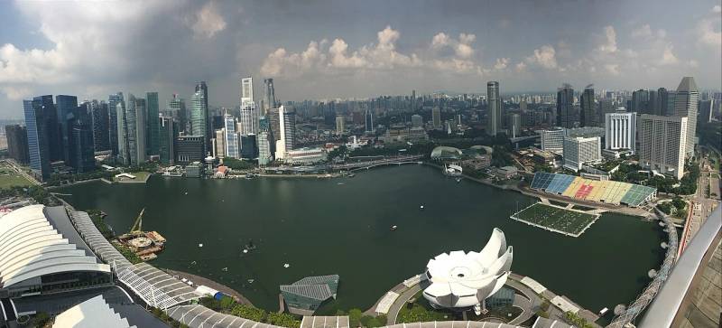 Panoramic view of Singapore financial district where wholesale institutional cross-border settlement infrastructure is piloted.