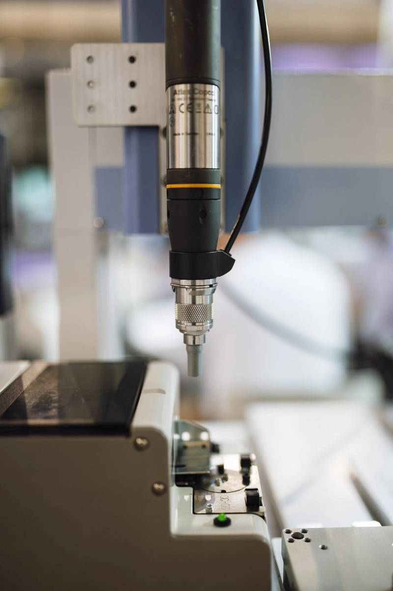 Precision automated robotic tooling on a modern manufacturing floor representing high-accuracy assembly operations.