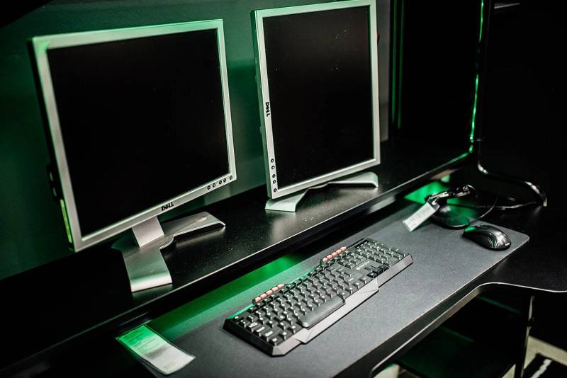 High-performance PC gaming battlestation displaying multi-monitor interactive simulation environment.